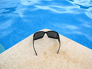 Sunglasses next to pool