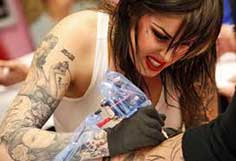 Women giving tattoo
